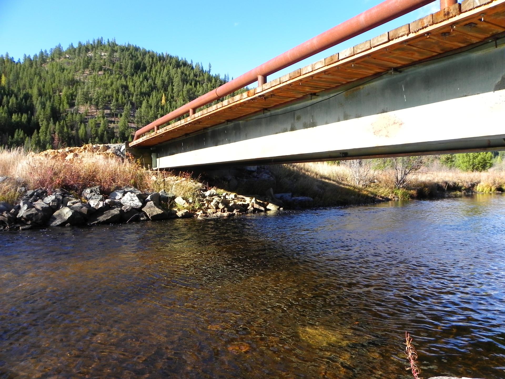 Missoula County creek and bridge with mountain. 
